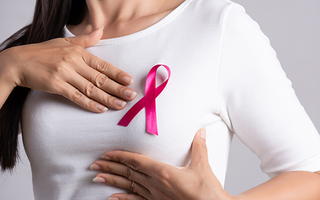 Breast self-exam and pink ribbon awareness image promoting early detection of breast cancer symptoms and recurrence.