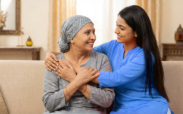 Elderly cancer patient receiving emotional support and care during recovery after cancer treatment